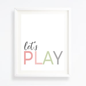May include: White framed print with the text "let's PLAY" in pink, green, and gray lettering.