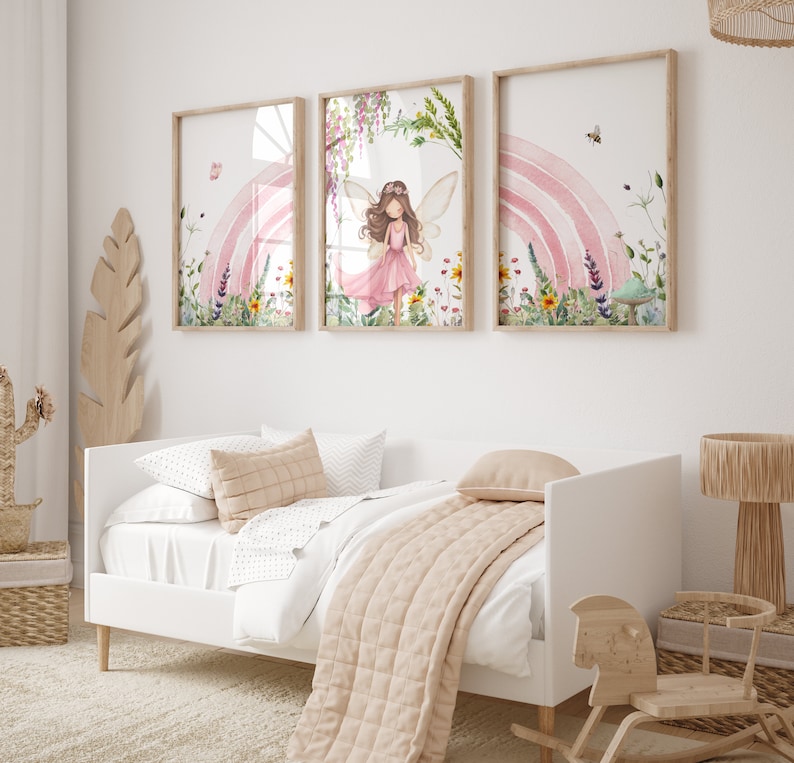 May include: Three framed prints with a watercolor style design. The center print features a fairy with pink wings and a pink dress standing in a field of flowers. The left and right prints feature a rainbow and flowers.