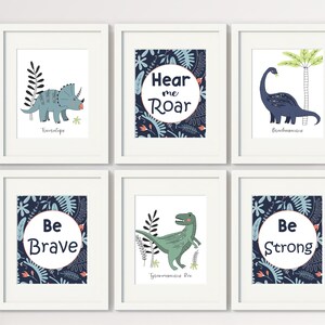 May include: Set of six blue and green dinosaur themed prints with motivational quotes. The prints feature illustrations of dinosaurs, including a Triceratops, Brachiosaurus, and Tyrannosaurus Rex. The quotes include "Hear me Roar", "Be Brave", and "Be Strong".