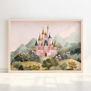 May include: A framed watercolor print of a pink castle with gold and blue turrets, set against a backdrop of green mountains and lush foliage. The artwork is in a light wood frame, creating a whimsical and fairytale-like scene.