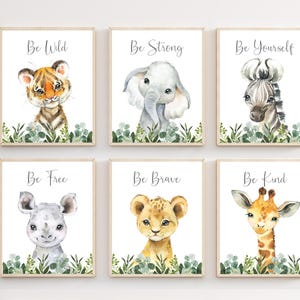 May include: Set of six printable nursery art prints featuring watercolor illustrations of animals with inspirational messages. The prints feature a tiger, elephant, zebra, rhinoceros, lion, and giraffe with the words "Be Wild", "Be Strong", "Be Yourself", "Be Free", "Be Brave", and "Be Kind" respectively.