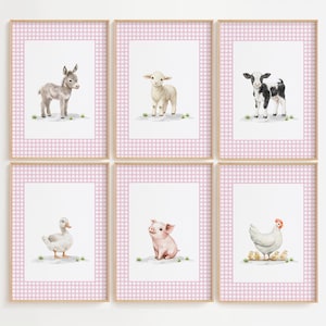 May include: Six framed watercolor prints featuring farm animals: a donkey, lamb, calf, duck, pig, and hen with chicks. Each animal is depicted on a white background with green accents, framed by a pink gingham pattern.