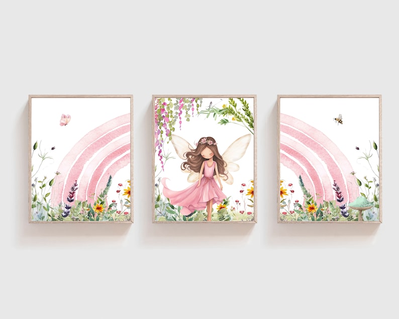 May include: Three watercolor paintings depicting a fairy with pink wings and a pink dress standing in a field of flowers with a pink rainbow in the background. The fairy is surrounded by green leaves and flowers. The paintings are framed in wood.