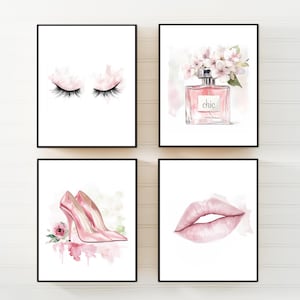 Puede incluir: Cuatro impresiones en acuarela enmarcadas con un tema femenino. Las impresiones presentan pestañas cerradas, un frasco de perfume con flores, tacones altos rosas y un par de labios rosas. La obra de arte está sobre un fondo blanco.
