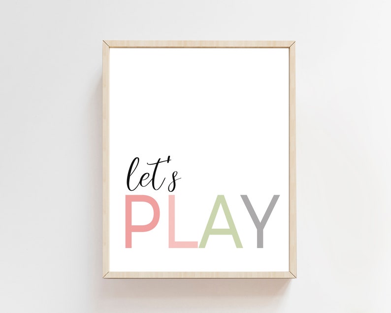 May include: A framed print with the text "Let's Play" in a playful font. The word "Play" is in pink, green, and gray.