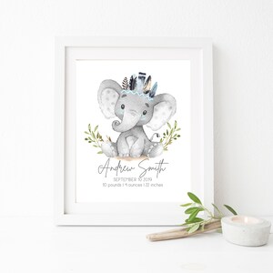 May include: A watercolor illustration of a gray elephant wearing a blue and white feather headdress. The elephant is sitting on a brown surface with green leaves. The text below the elephant reads "Andrew Smith, September 10, 2019, 10 pounds 11 ounces | 22 inches".
