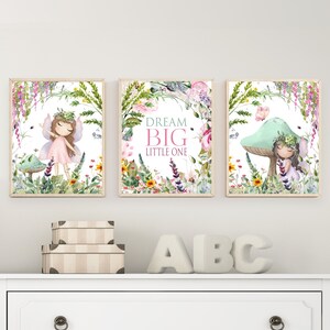 May include: Three framed watercolor prints featuring fairies in a whimsical forest setting. The center print features the text "Dream Big Little One".