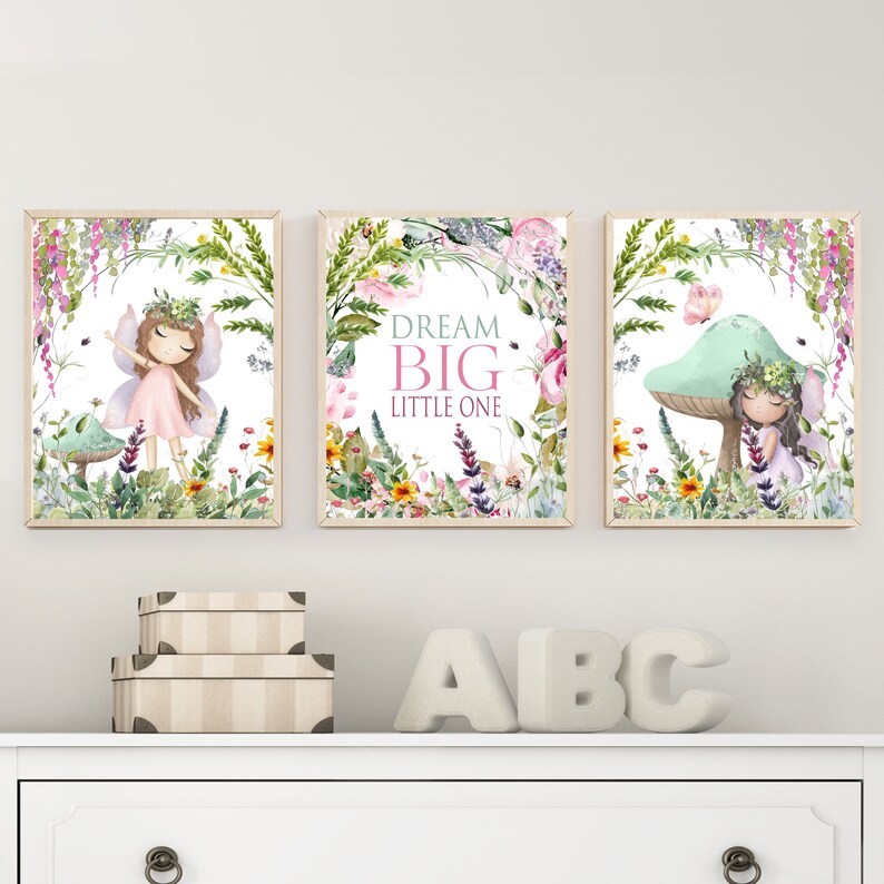 May include: Three framed watercolor prints featuring fairies in a whimsical forest setting. The center print features the text "Dream Big Little One".