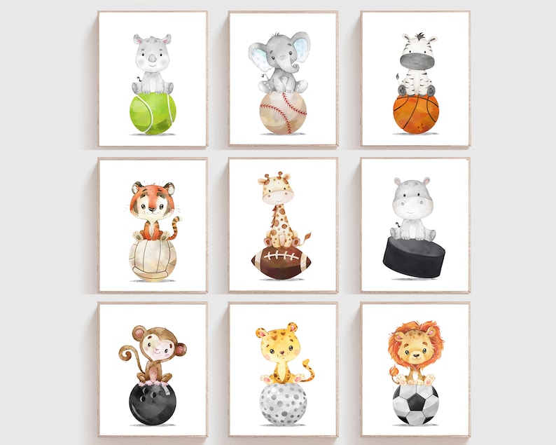 May include: Nine watercolor illustrations of different animals sitting on top of various sports balls. The animals include a rhino, elephant, zebra, tiger, giraffe, hippopotamus, monkey, leopard, and lion. The sports balls include a tennis ball, baseball, basketball, volleyball, football, hockey puck, bowling ball, golf ball, and soccer ball.