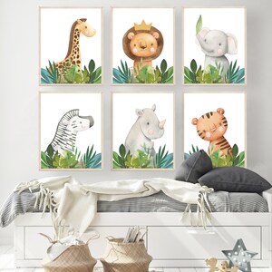May include: Six watercolor animal prints featuring a giraffe, lion, elephant, zebra, rhinoceros, and tiger. Each animal is surrounded by green leaves and set against a white background.