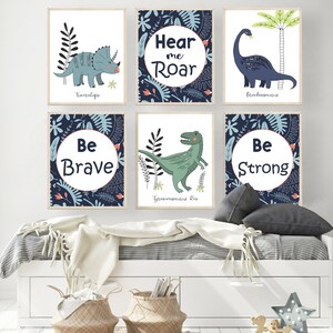 May include: Six blue and white illustrated dinosaur posters with motivational phrases. The posters feature a Triceratops, Brachiosaurus, Tyrannosaurus Rex, and the phrases "Hear me Roar", "Be Brave", and "Be Strong".
