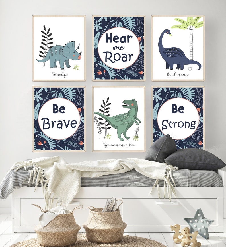 May include: Six blue and white illustrated dinosaur posters with motivational phrases. The posters feature a Triceratops, Brachiosaurus, Tyrannosaurus Rex, and the phrases "Hear me Roar", "Be Brave", and "Be Strong".