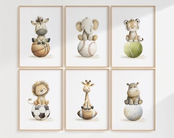 May include: Set of six framed watercolor prints featuring adorable baby animals. A zebra, elephant, and tiger sit atop a basketball, baseball, and tennis ball. A lion, giraffe, and hippo sit on a soccer ball, football, and golf ball.