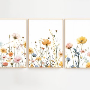 May include: A set of three watercolor prints featuring a floral arrangement of yellow, pink, and blue wildflowers on a white background.