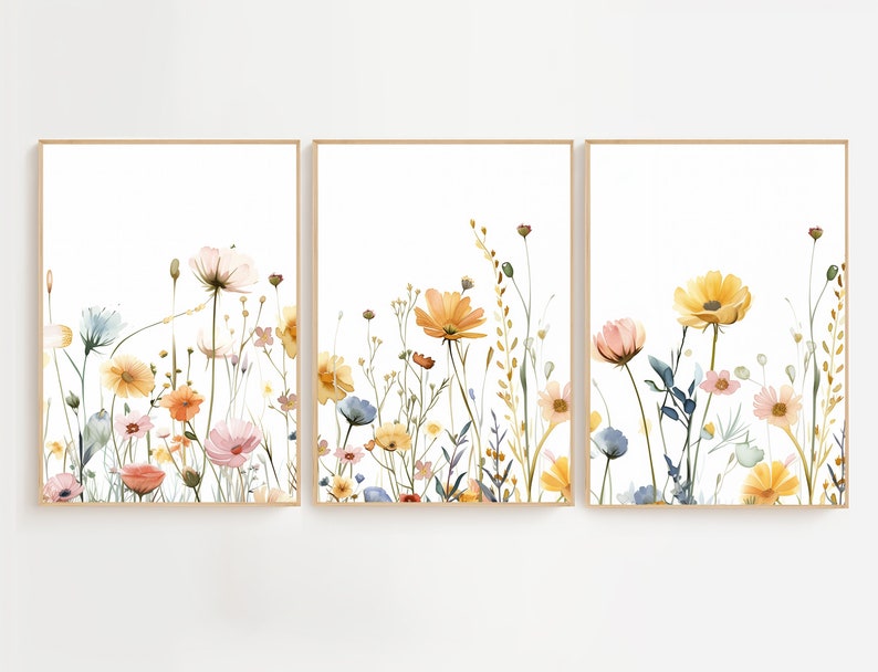 May include: A set of three watercolor prints featuring a floral arrangement of yellow, pink, and blue wildflowers on a white background.
