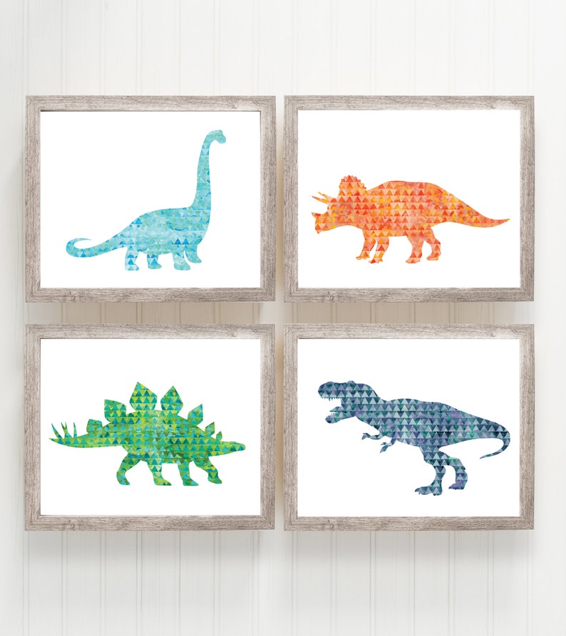 May include: Set of four framed prints featuring watercolor dinosaur silhouettes in a geometric pattern. The dinosaurs are a blue brachiosaurus, an orange triceratops, a green stegosaurus, and a blue T-Rex.