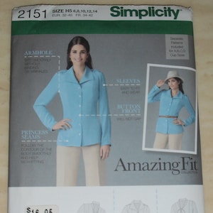May include: Simplicity sewing pattern 2151 for a button-front shirt. The pattern features princess seams and sleeves designed for easy fitting. The cover shows a woman wearing a light blue shirt with the text "Amazing Fit Collection".