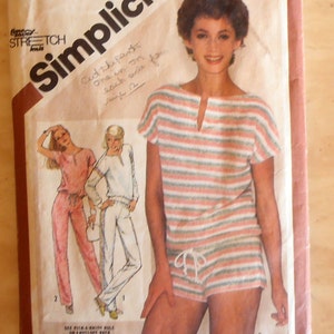May include: Simplicity sewing pattern number 9890 for a striped knit top and shorts. The pattern is for sizes 12, 14, and 16. The pattern cover features a model wearing the completed garment.