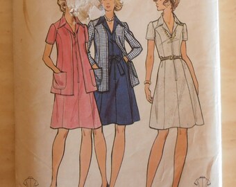 May include: A vintage sewing pattern for a dress, featuring three women wearing different styles of dresses. The pattern is for sizes 10-18 and 38-42. The pattern is from Butterick and is number 6982. The price is $1.00.