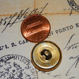 May include: A close-up of a copper penny with the Lincoln Memorial on the front and the words "One Cent" on the back. The penny is sitting on a piece of paper with writing on it.