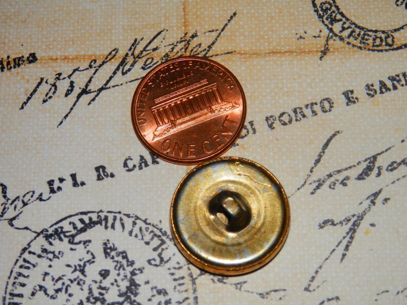 May include: A close-up of a copper penny with the Lincoln Memorial on the front and the words "One Cent" on the back. The penny is sitting on a piece of paper with writing on it.