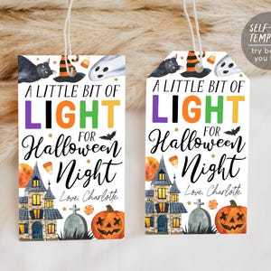May include: Two Halloween-themed gift tags with the text "A Little Bit of Light for Halloween Night." Each tag features a black cat, witch hat, ghost, haunted house, pumpkin, and the name "Charlotte."