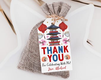 May include: A burlap drawstring favor bag with a rectangular paper tag attached by twine. The tag features a pagoda, red lanterns, cherry blossoms, sushi rolls, and the text "THANK YOU For Celebrating With Me! Love, Michael."