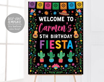 May include: A black rectangular birthday sign featuring the text WELCOME TO Carmen's 5TH BIRTHDAY FIESTA. The design includes colorful papel picado banners, a sombrero, guitars, and cacti, all framed by a vibrant floral vine border.