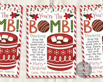 May include: Three rectangular gift tags with red and white striped borders, featuring a red mug with marshmallows, a chocolate sphere, and text reading You're The BOMB! Directions: Drop the chocolate bomb into a mug. Slowly pour 8 oz hot milk.