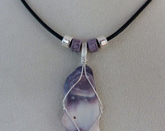 Cape Cod wampum shell wrapped in fine silver on black leather cord. Purple, white, lavender.