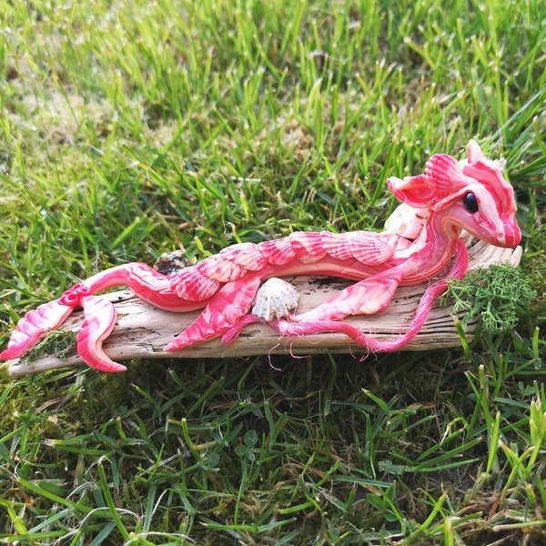 Hand-crafted spirit doll of a Loch dragon called "Lomond" resting on driftwood, blessed with sage oil