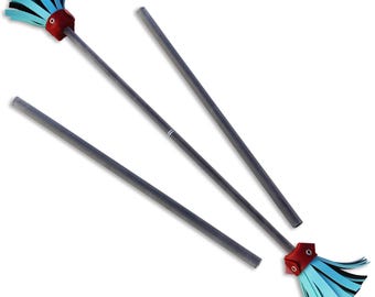 May include: Three silver juggling sticks with blue and black pom-poms on the ends. The pom-poms have a red leather band around the base.