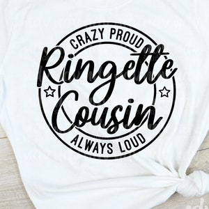 May include: A white t-shirt with a black circle design that says "Crazy Proud Ringlett Cousin Always Loud". The design is also shown on a wood background.