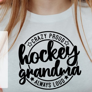 May include: A white t-shirt with a black circle design that says "Crazy Proud Hockey Grandma Always Loud".