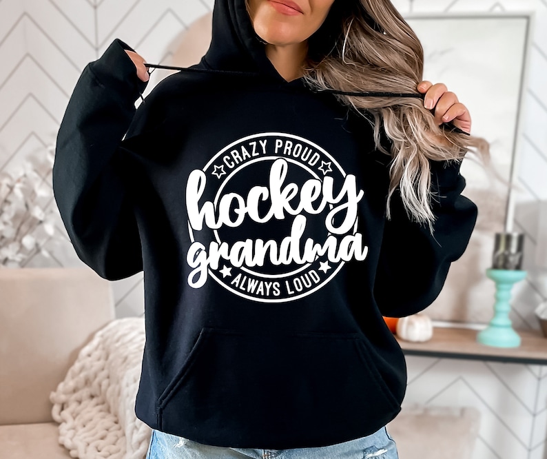 May include: Black hoodie with a white circle graphic that says "Crazy Proud Hockey Grandma Always Loud".