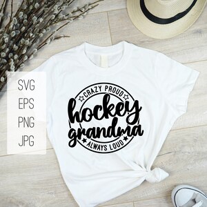 May include: White t-shirt with a black circle design that says "Crazy Proud Hockey Grandma Always Loud" with stars around the circle.