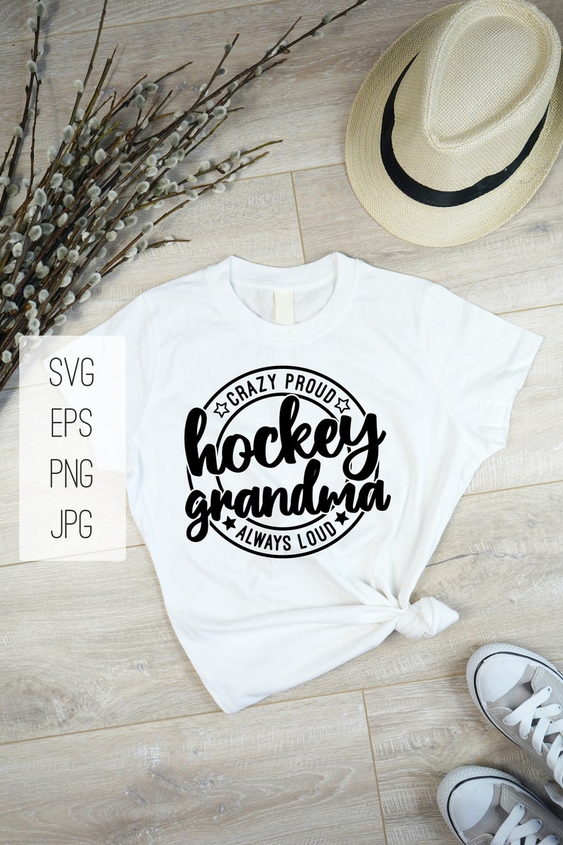 May include: White t-shirt with a black circle design that says "Crazy Proud Hockey Grandma Always Loud" with stars around the circle.