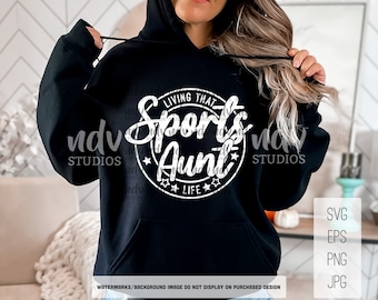 May include: Black hoodie with a white circle graphic that says "Living That Sports Aunt Life" in a handwritten font.