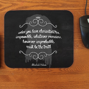 May include: Black and white mouse pad with a quote from Sherlock Holmes: "When you have eliminated the impossible, whatever remains, however improbable, must be the truth."