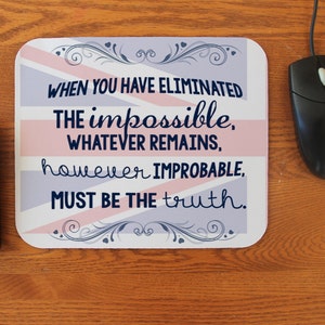 May include: A pink and blue mouse pad with a quote that reads "WHEN YOU HAVE ELIMINATED THE impossible, WHATEVER REMAINS, however IMPROBABLE, MUST BE THE truth."