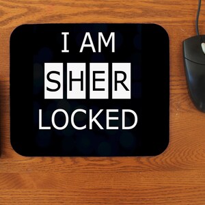 May include: Black mouse pad with the text "I am Sherlocked" in white letters.
