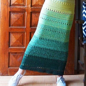 May include: A handmade, ombre crochet skirt in shades of green and yellow. The skirt is worn with a white top and sneakers. The text "courtesy of instagram.com/hookedonyarns" is visible at the bottom.