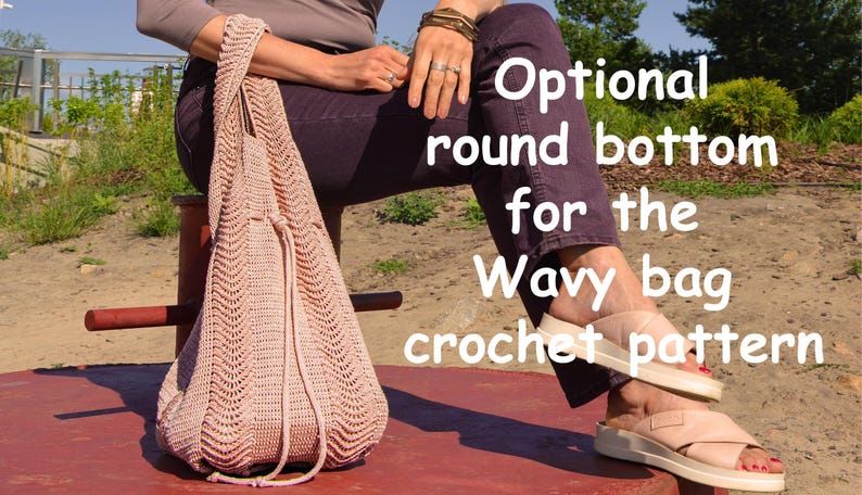 May include: A light pink crocheted bag with a drawstring closure. The bag has a wavy pattern and is held by a person sitting on a red bench. Text on the image reads "Optional round bottom for the Wavy bag crochet pattern."