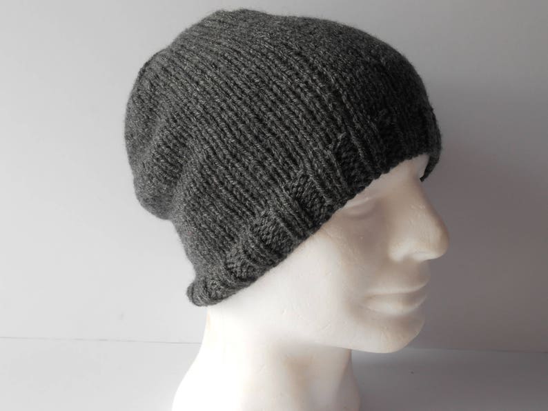 May include: A gray knitted beanie hat with a ribbed texture.