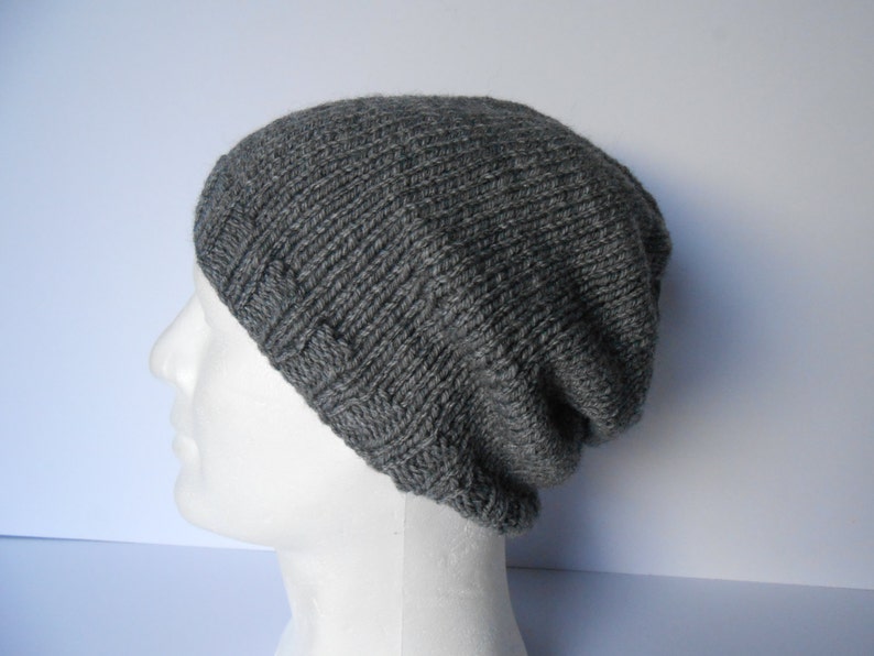 May include: A gray knitted beanie hat with a ribbed texture.