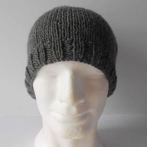 May include: A gray knitted beanie hat with a ribbed texture.