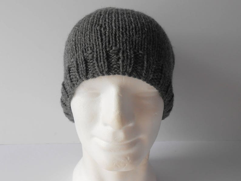 May include: A gray knitted beanie hat with a ribbed texture.