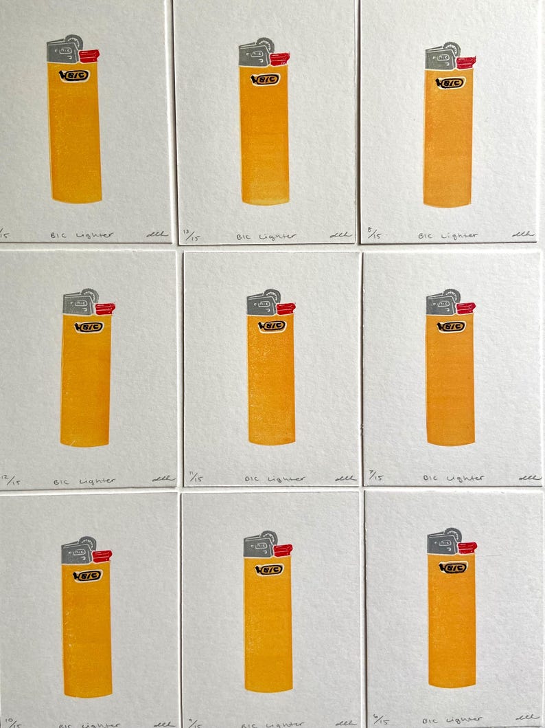 Op de afbeelding: Negen afdrukken van een gele BIC-aansteker met een grijze bovenkant en rode ontstekingsknop. Elke afdruk staat op een witte vierkant, met de tekst "BIC lighter" eronder. De afdrukken zijn gerangschikt in een raster.