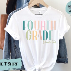 May include: White t-shirt with the text "FOURTH GRADE Dream Team" in colorful letters. The shirt is made of a soft, comfortable fabric.