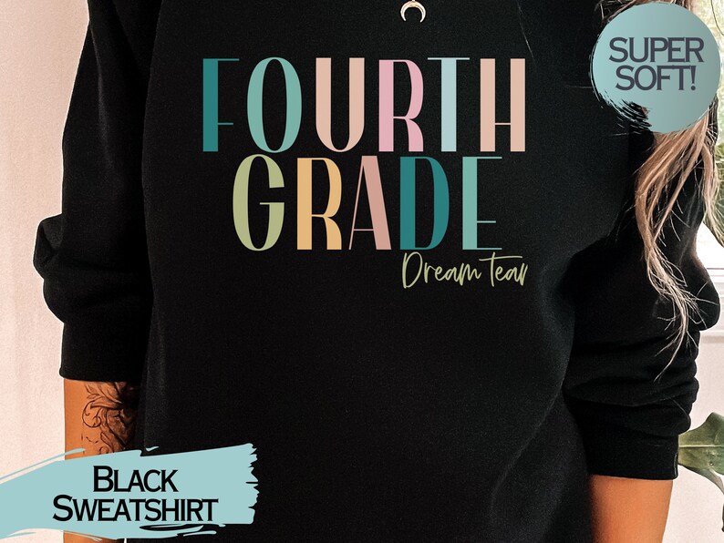 May include: Black sweatshirt with the text "FOURTH GRADE Dream Team" in colorful letters. The text "SUPER SOFT!" is in a blue circle on the upper right corner of the sweatshirt.